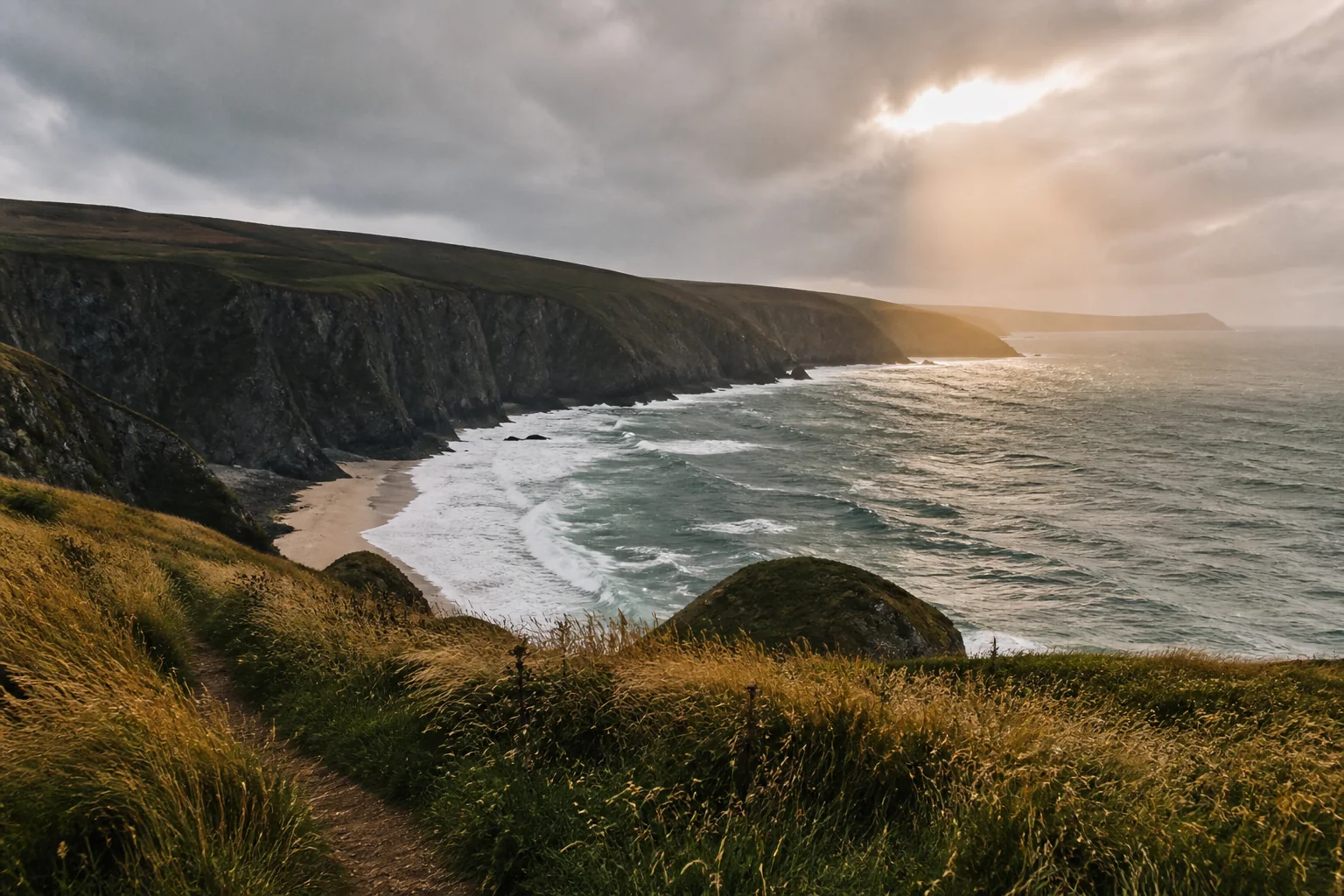A grassy clifftop path overlooking a quiet Atlantic-style inlet